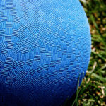 A blue ball and green grass