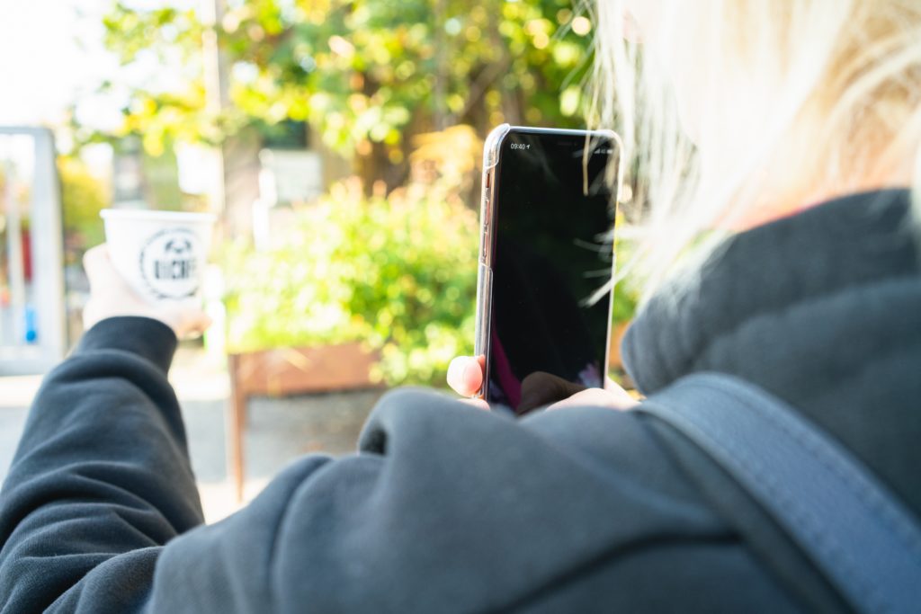 A man sitting in a chair talking on a cell phone